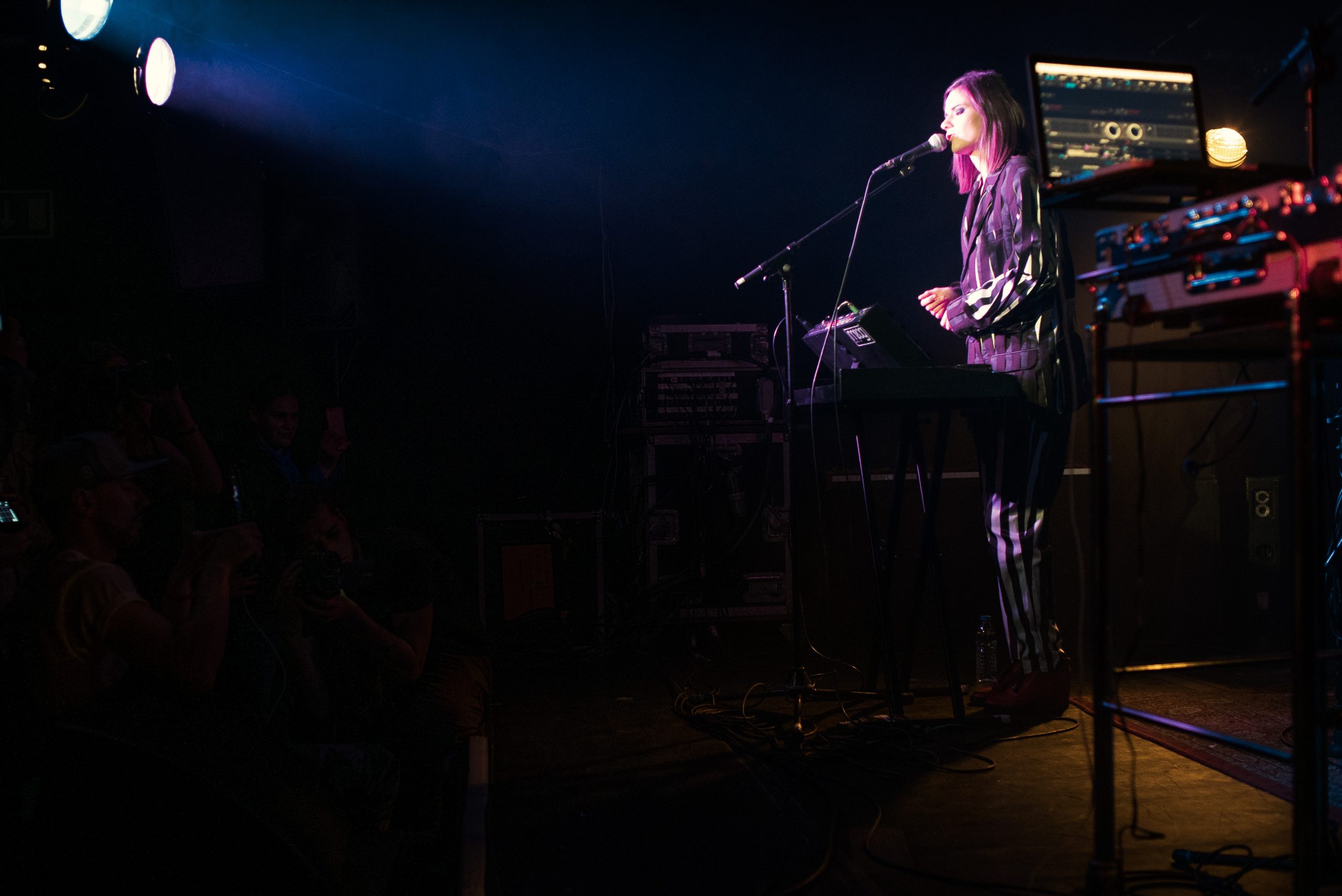 person singing playing keyboard